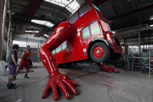 Workers check the function of the hydraulic arms of a London bus that is being transformed into a robotic sculpture by Czech artist David Cerny in Prague
