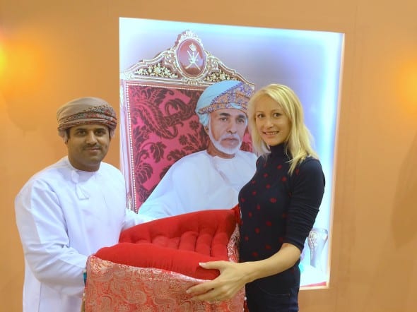 Diana Stauer with Moosa Saud Al-Harbi. Sultanate of Oman Royal Cavalry pavilion. Picture of Sultan of Oman. Traditional horse saddle demonstrated at the stand. 
