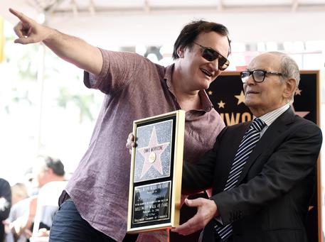 Italian composer Ennio Morricone, right, poses with director Quentin Tarantino after receiving a star on the Hollywood Walk of Fame on Friday, Feb. 26, 2016, in Los Angeles. Morricone is nominated for an Academy Award in Sunday's Oscars ceremony for Best Original Score for Tarantino's film "The Hateful Eight." (Photo by Chris Pizzello/Invision/ANSA/AP)