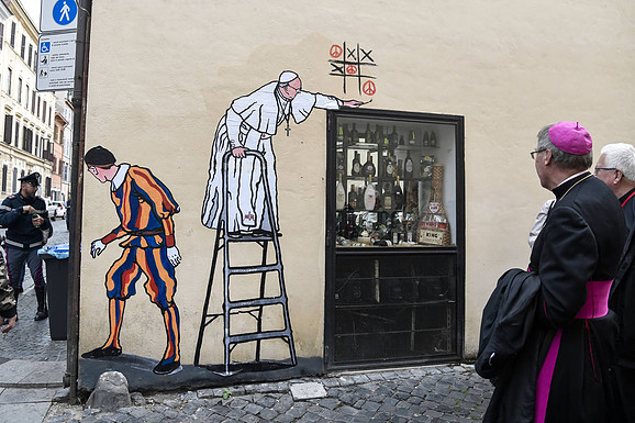 Super Pope - Street Artist Pope Reuters.com/AFP PHOTO/TIZIANA FABI