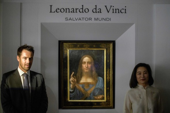 Christies representatives pose after Leonardo da Vinci's 'Salvator Mundi' painting was unveiled in Hong Kong on October 13, 2017.  / AFP PHOTO / Anthony WALLACE / RESTRICTED TO EDITORIAL USE - MANDATORY MENTION OF THE ARTIST UPON PUBLICATION - TO ILLUSTRATE THE EVENT AS SPECIFIED IN THE CAPTION        (Photo credit should read ANTHONY WALLACE/AFP/Getty Images)
