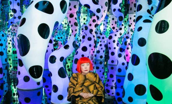 Yayoi Kusama with her work LOVE IS CALLING during her solo exhibition “I Who Have Arrived In Heaven” at David Zwirner in New York in 2013. ©YAYOI KUSAMA/COURTESY DAVID ZWIRNER, NEW YORK; OTA FINE ARTS, TOKYO, SINGAPORE, AND SHANGHAI; AND VICTORIA MIRO, LONDON AND VENICE