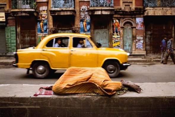 Person sleeping under a yellow blanket, India, 1996