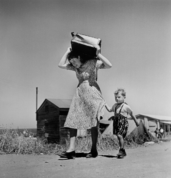Robert Capa, Woman carrying luggage accompanied by a small boy. Haifa. ISRAEL. 1949-50 @ Magnum Photos