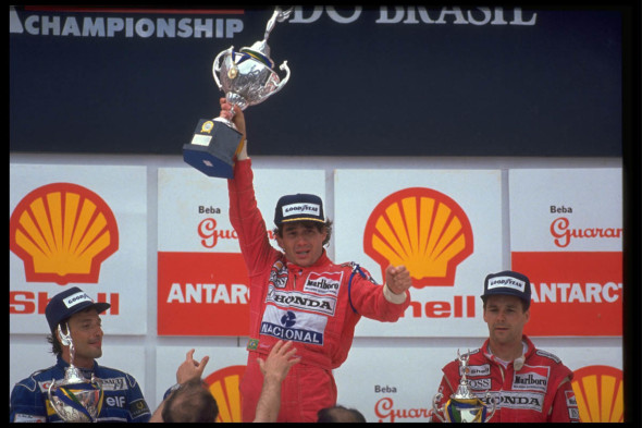 Interlagos - G.P. Brasile, 1991 Ayrton Senna con Riccardo Patrese e Gerhard Berger. Senna vince per la prima volta la corsa di casa. Sofferente sul podio dopo aver guidato a lungo con il cambio bloccato. © FOTO ERCOLE COLOMBO