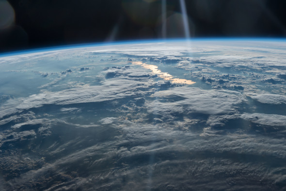 Beams of Light on a Golden Lake, image taken by the Expedition 47 crew on May 31, 2016, from the International Space Station looks from northwestern China on the bottom into eastern Kazakhstan courtesy of NASA
