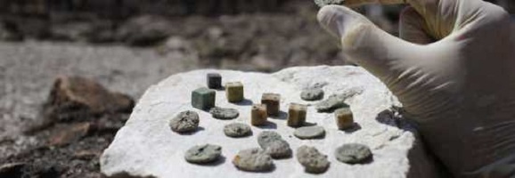 monete e dadi ritrovati durante gli scavi nell'Anfiteatro Flavio